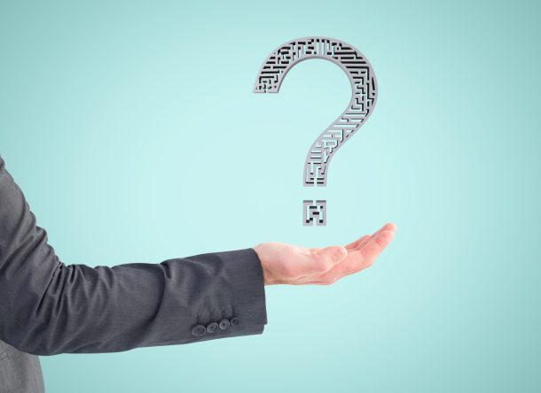 composite of hand holding questionmark graphic with blue background